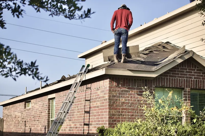 Professional roofer working on a residential roof in Wetmore